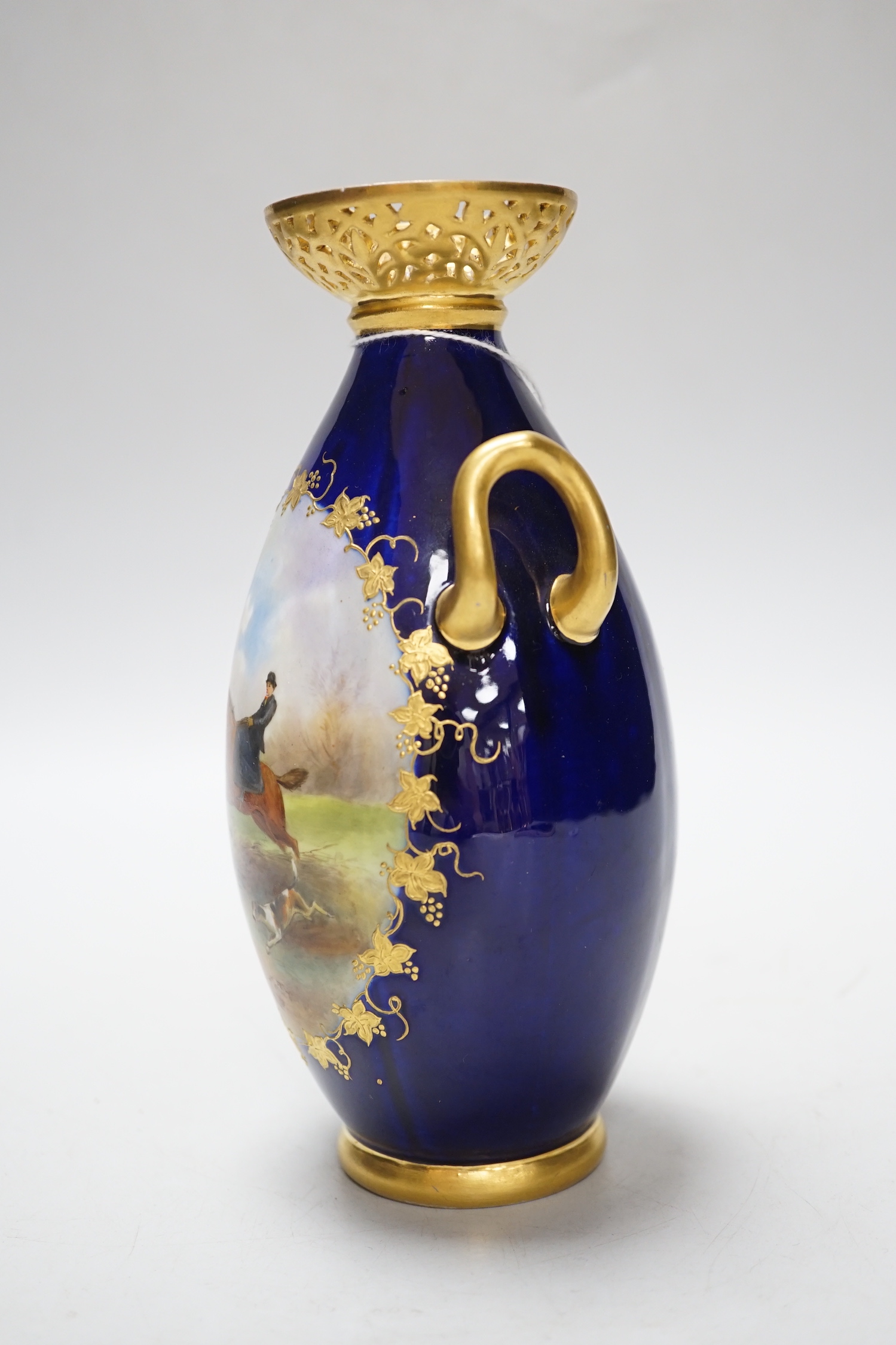 A Grainger & Co. Worcester two handled vase painted with a fox hunting scene in a raised gilt panel on a cobalt blue ground, having a reticulated gilt neck, date mark 1898, 19cm high